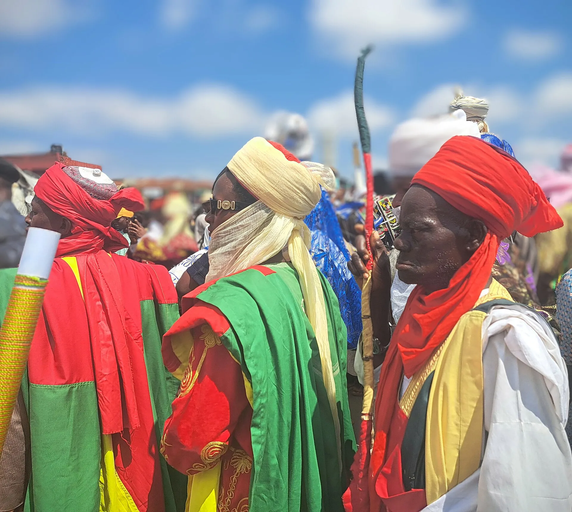 Palace guards at the Ilorin durbar in Nigeria, in red, green, and gold robes with tall turbans.