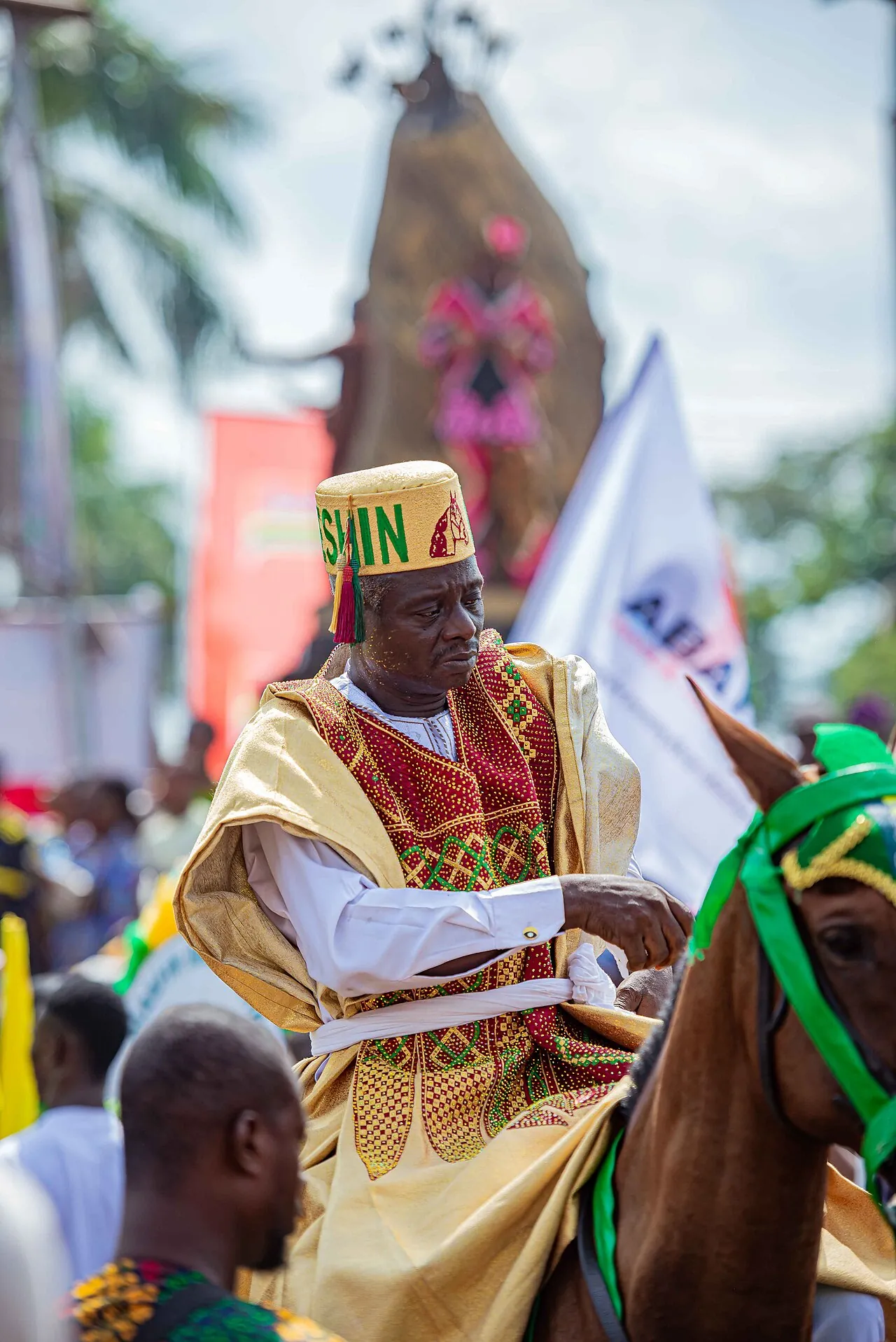 A horseman at Ojude Oba in a gold agbada and embroidered cap.